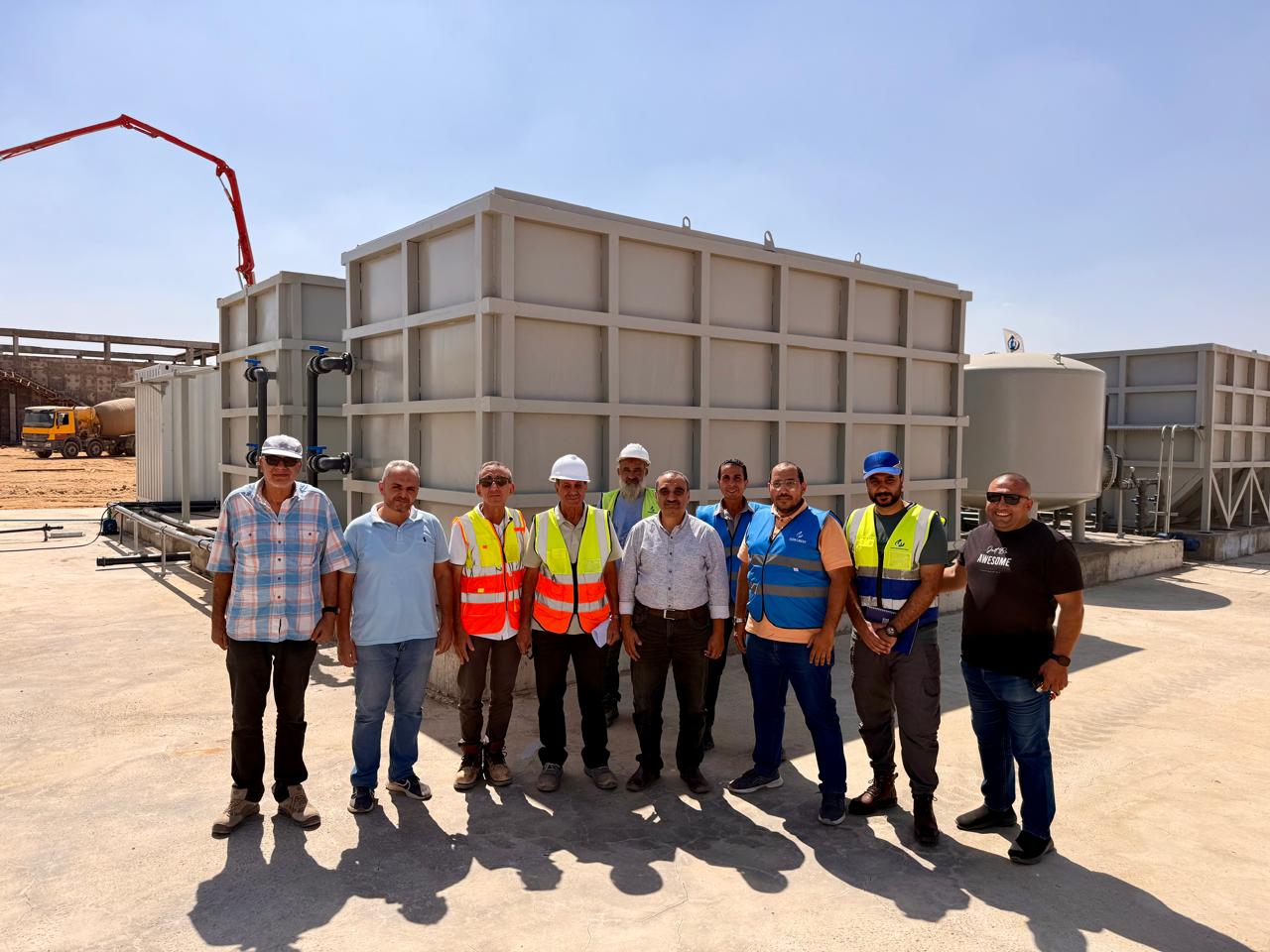 Project team group photograph in front of Noor City treatment plant equipment