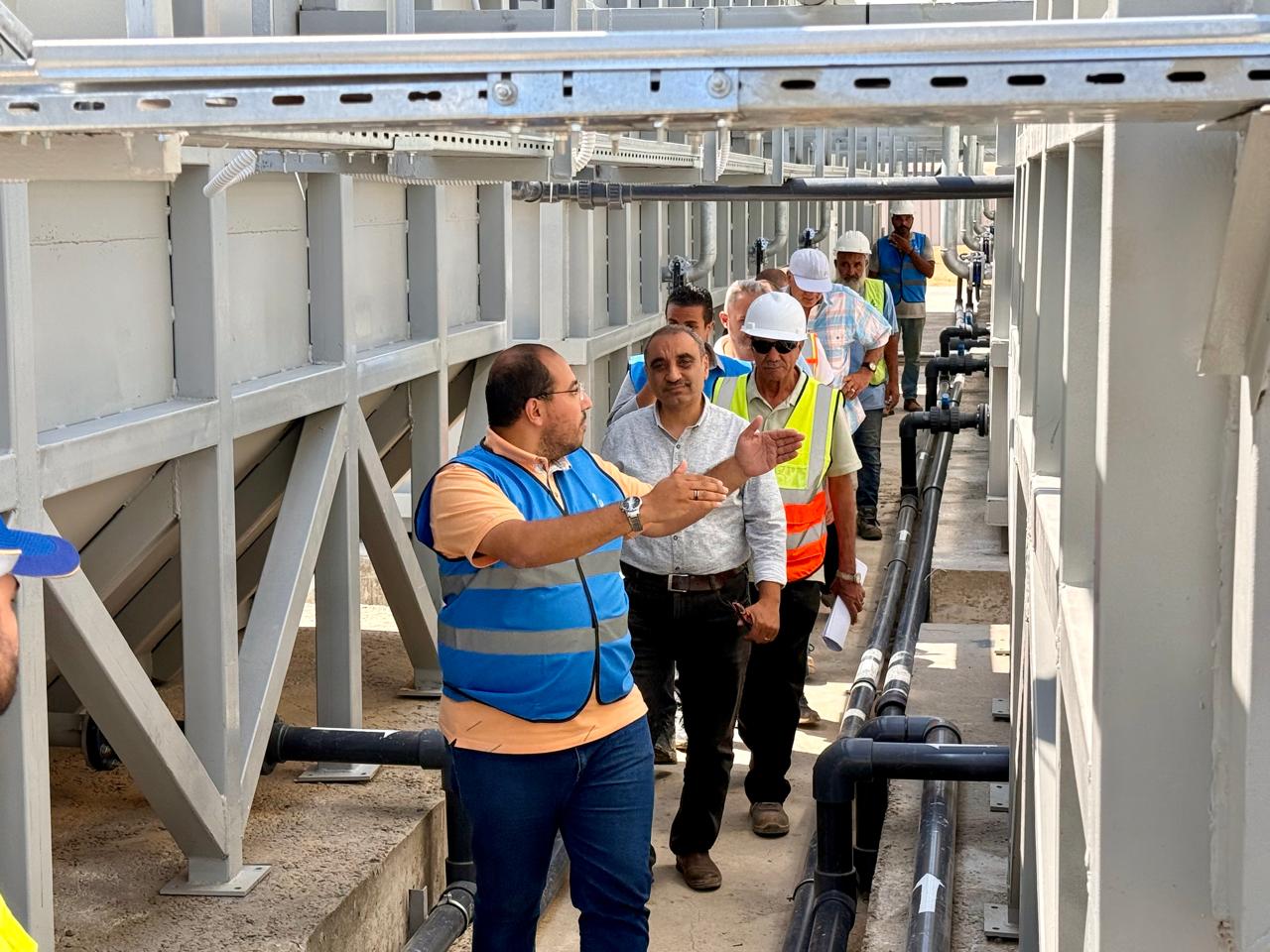 Team site visit between the Noor City treatment plant tanks